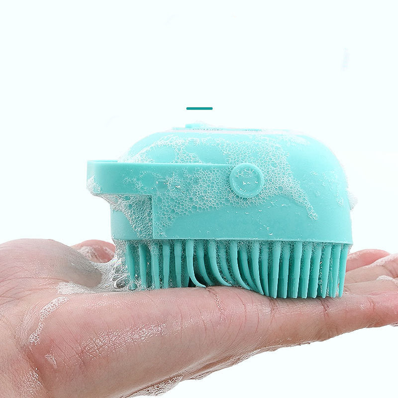 2-in-1 Pet Shampoo Brush held in hand, featuring a soapy design perfect for pet grooming.