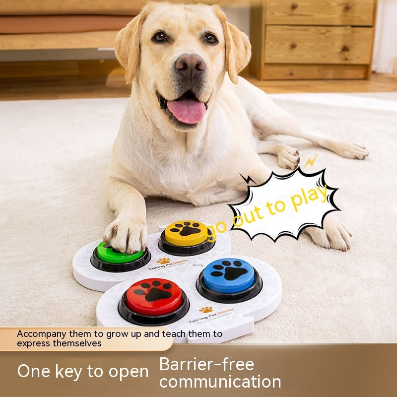 Dog using voice button toy for communication with colorful buttons on the floor, promoting interactive play and expression.