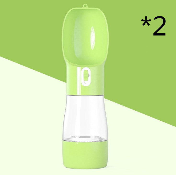 Green portable dog water dispenser with a cap and transparent water chamber, perfect for outdoor use.