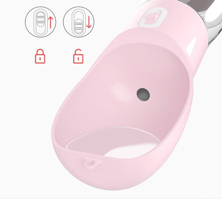 Close-up of a pink portable dog water dispenser with locking feature and water outlet.