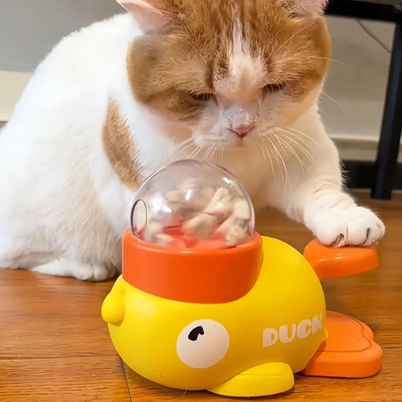 Cat interacting with an interactive duck feeder toy, enhancing mealtime play and slow feeding.