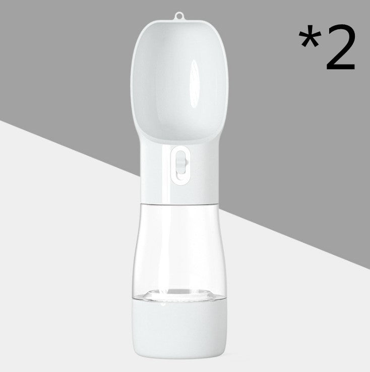 Portable dog water dispenser bottle with food compartment for travel and outdoor activities.